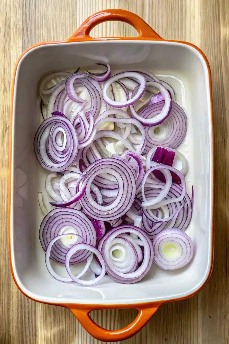 sticky-bbq-chicken-bake-2 Fresh red onion sliced into thin, even rounds for Sticky BBQ Chicken Bake